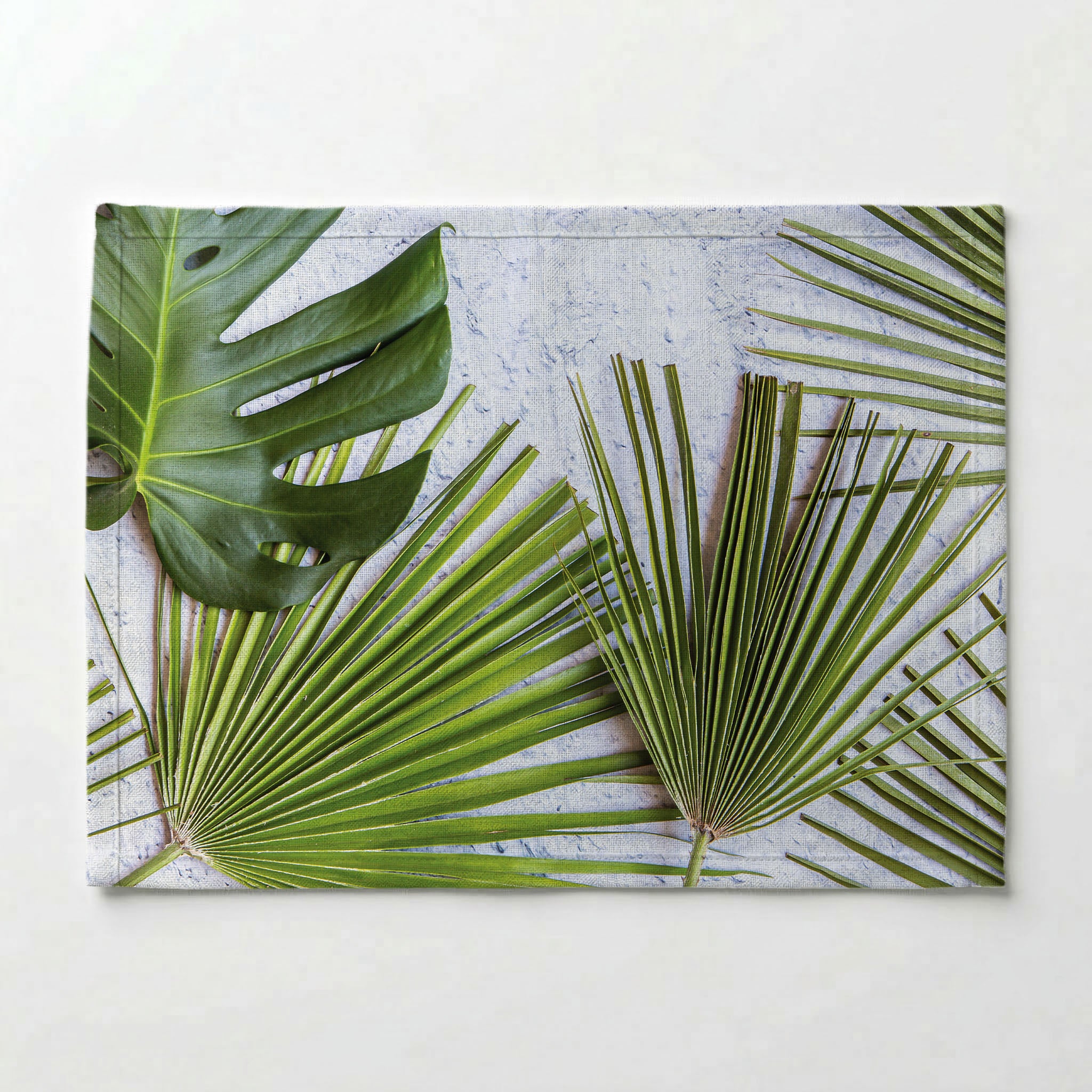 LEAVES GREEN PALM LEAVES ON WHITE PLACEMAT