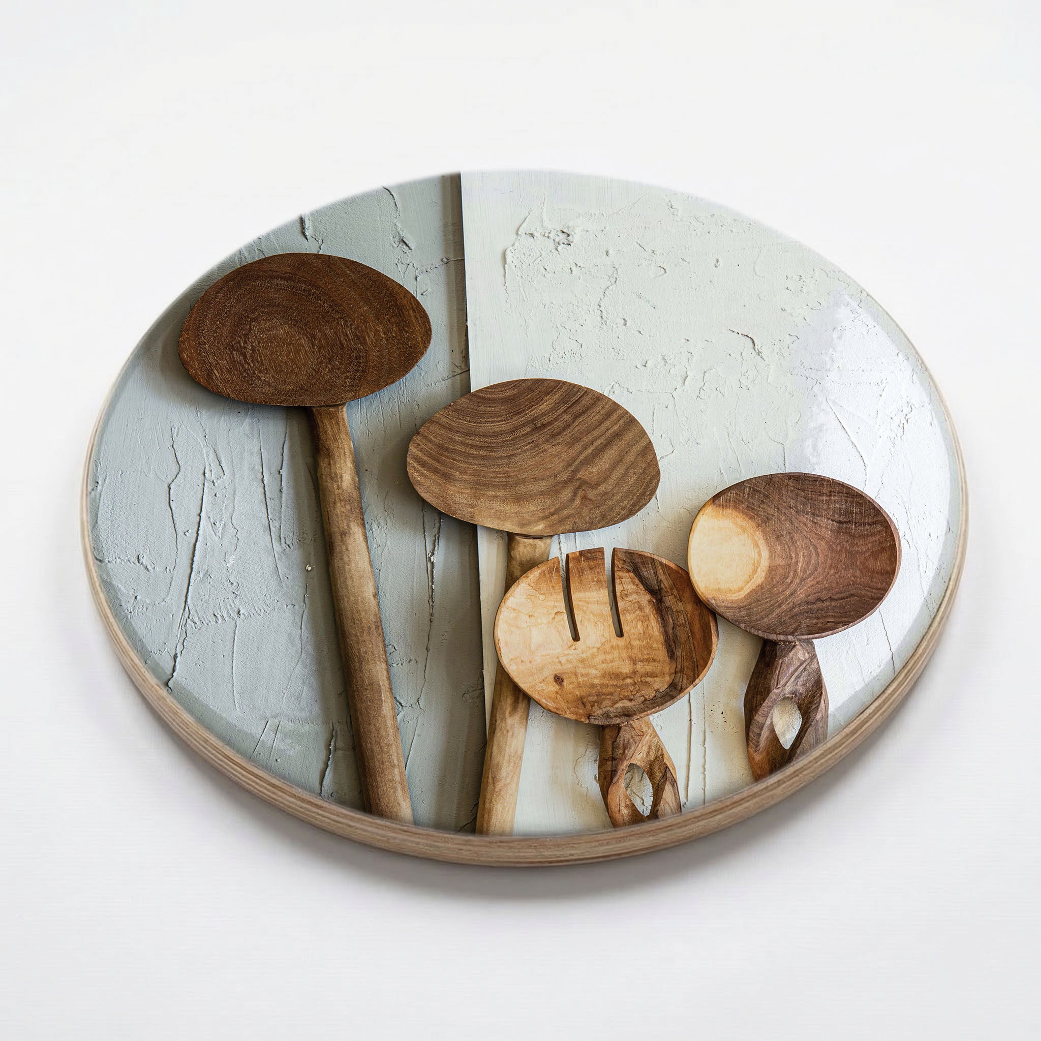 NATURAL BROWN WOODEN SPOONS ON GREY AND WHITE CHEESEBOARD
