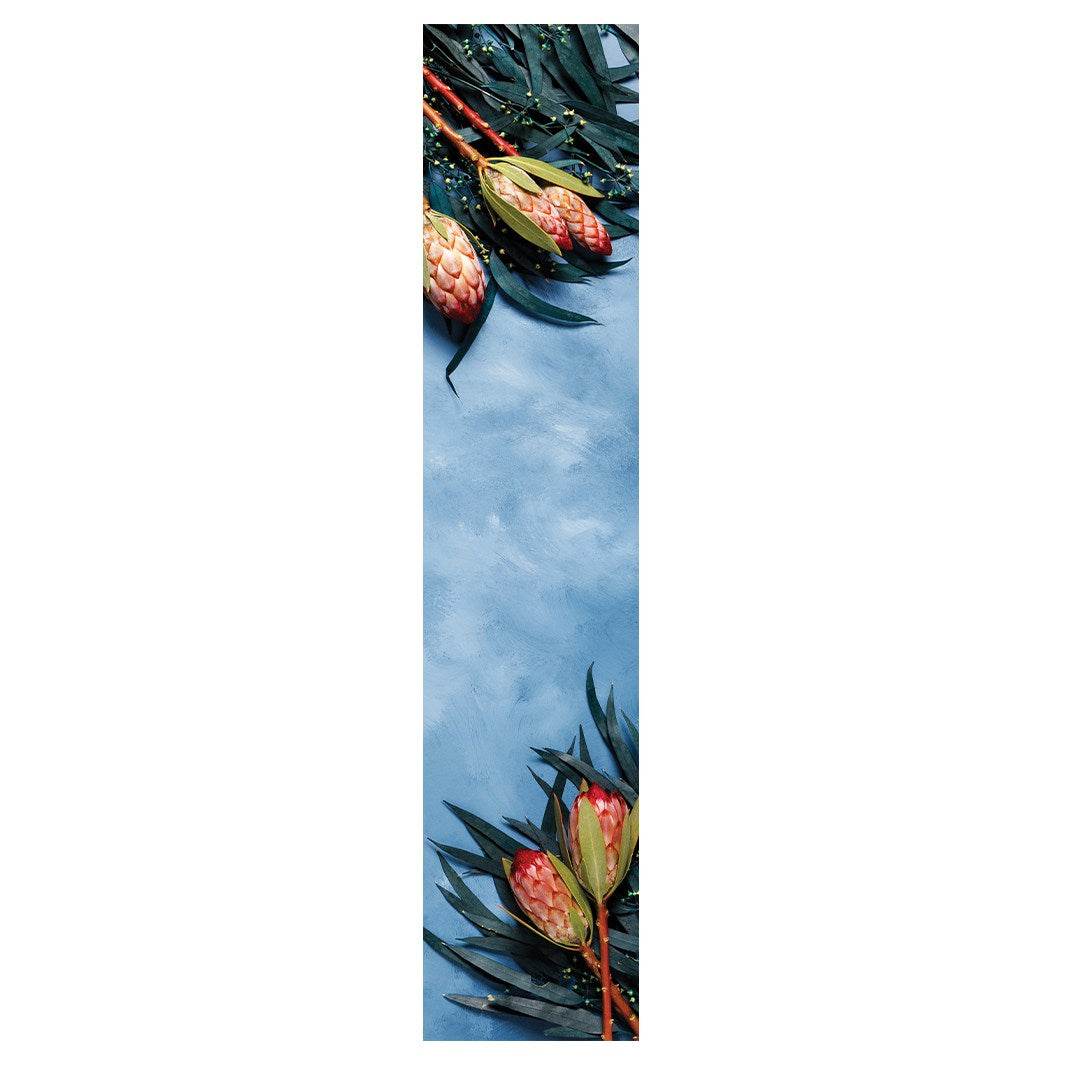PINK PROTEAS WITH EUCALYPTUS ON BLUE TABLE RUNNER