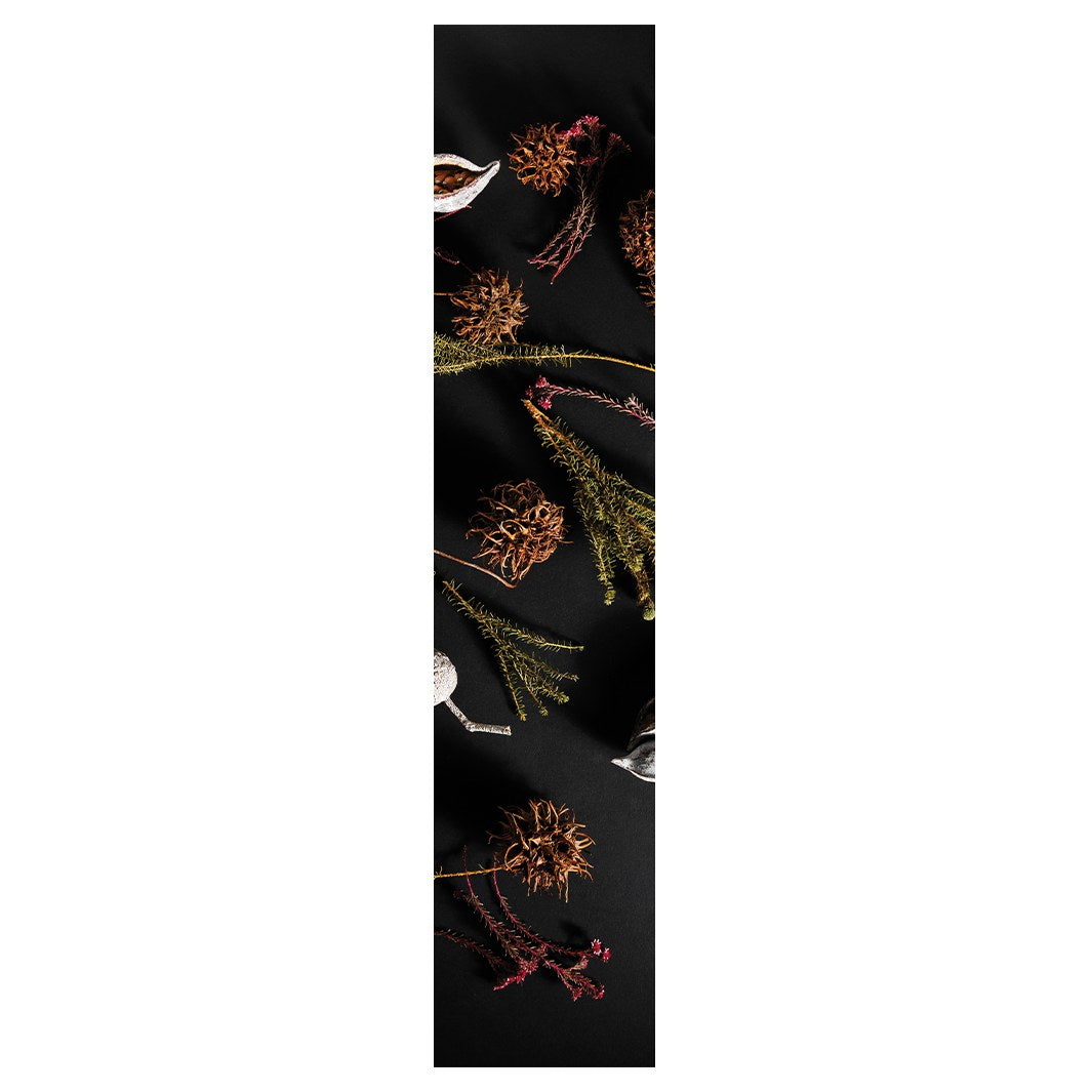 DRIED PODS, SPRIGS, AND SEEDS ON BLACK TABLE RUNNER