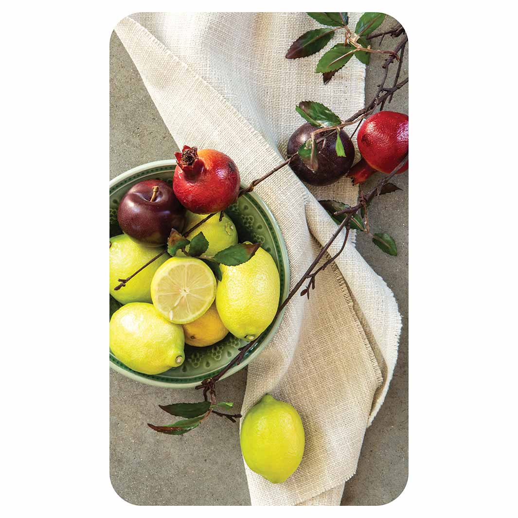 NATURAL RED POMEGRANATES AND LEMONS WITH LINEN KITCHEN TOWEL