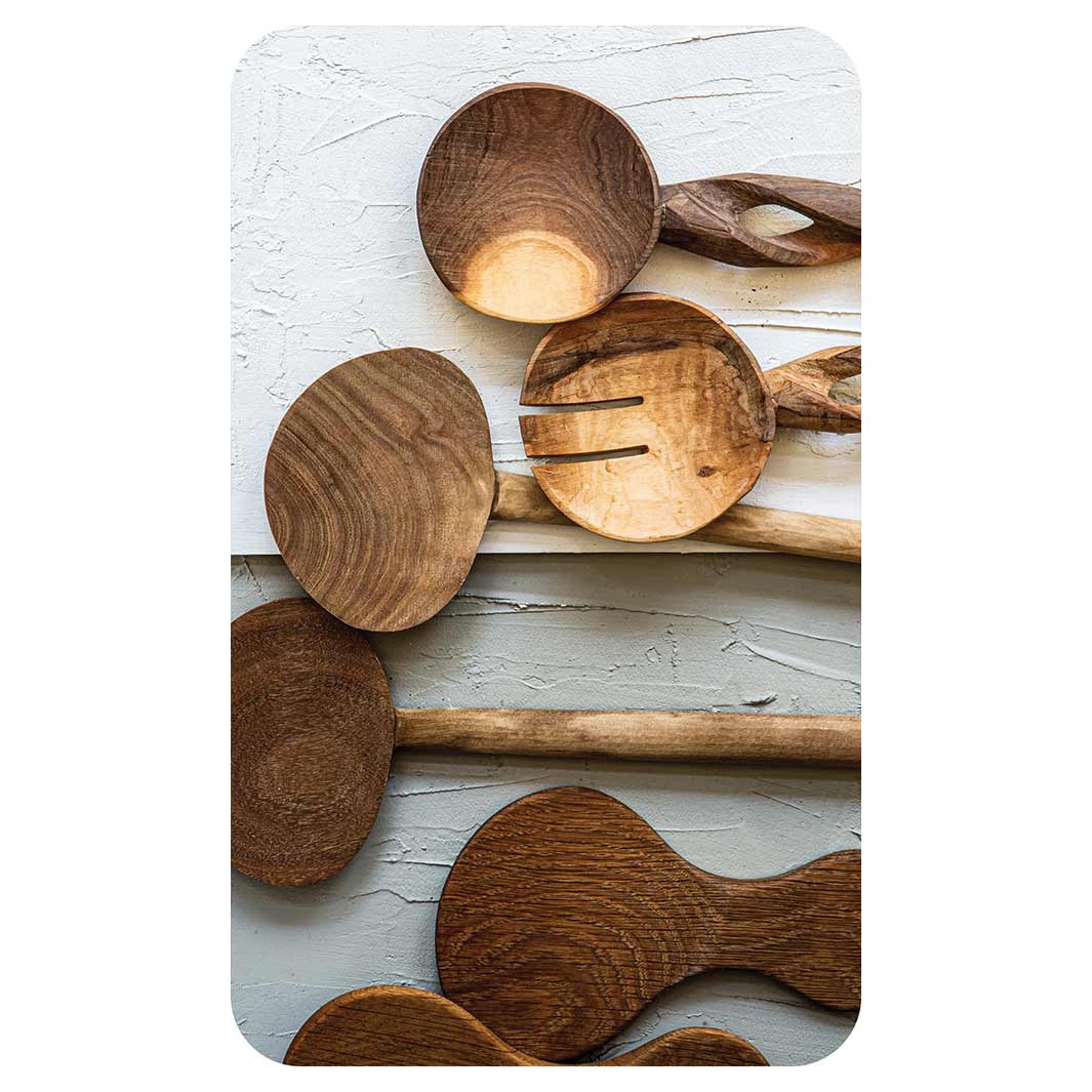 NATURAL BROWN WOODEN SPOONS ON GREY AND WHITE KITCHEN TOWEL