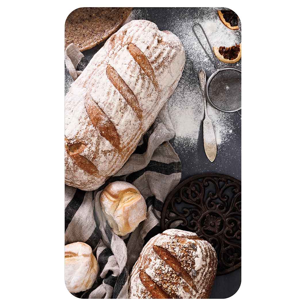 BREADS AND DRIED FRUIT ON BLACK KITCHEN TOWEL