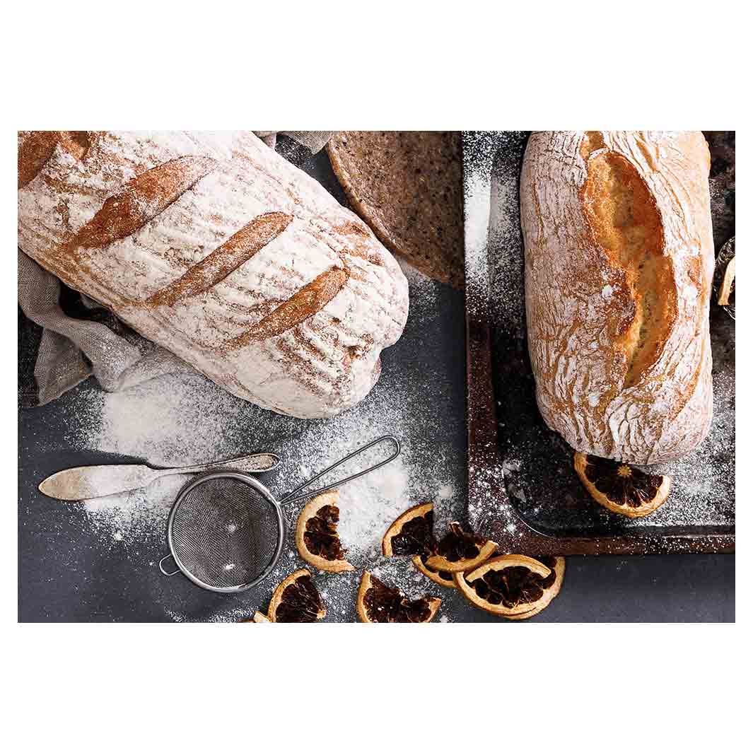 BREADS AND DRIED FRUIT ON BLACK RECTANGULAR PLACEMAT