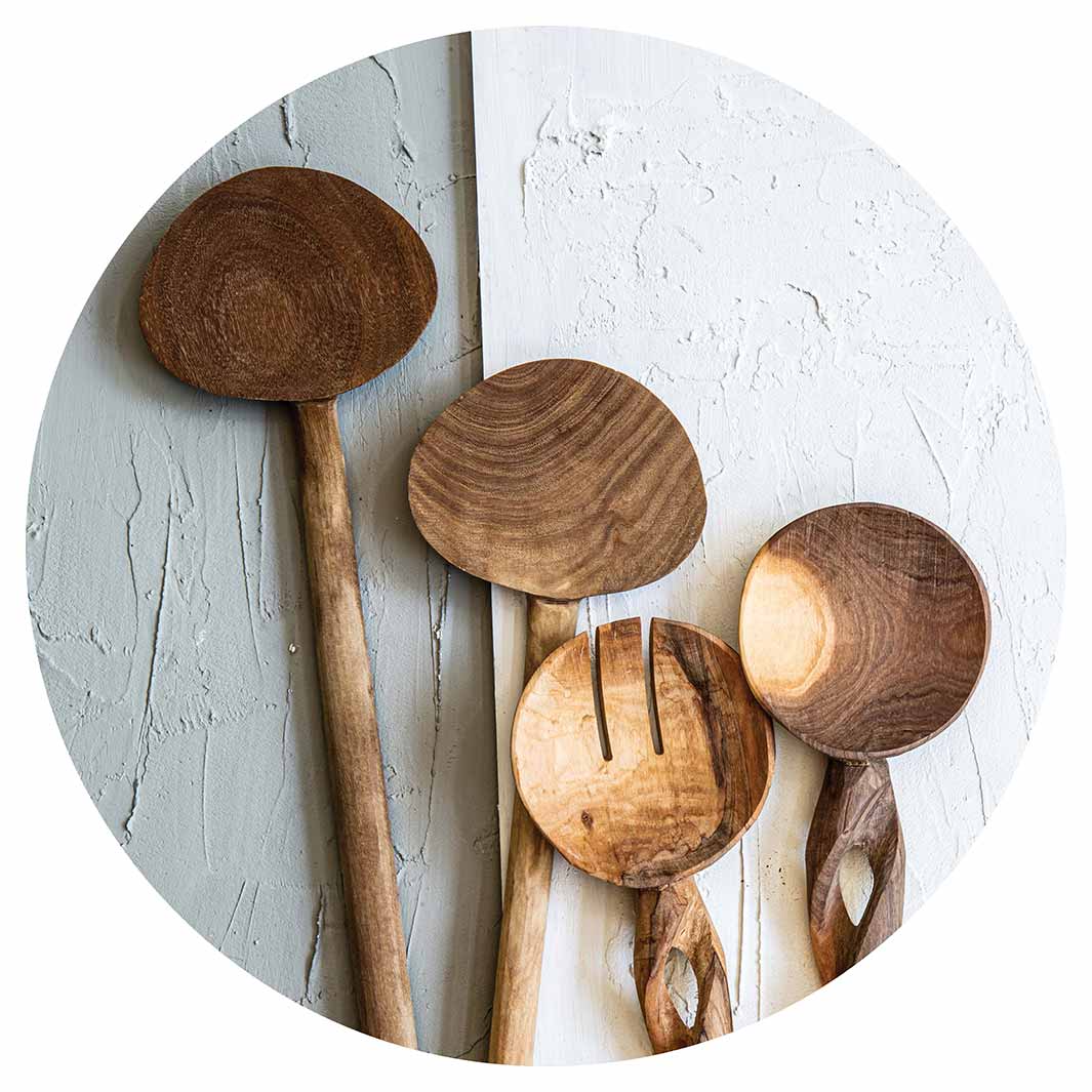 NATURAL BROWN WOODEN SPOONS ON GREY AND WHITE SERVING BOARD