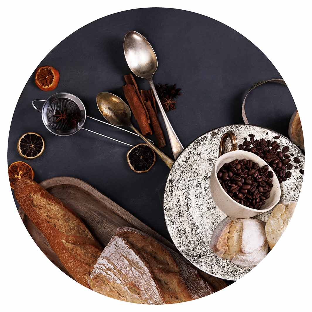 BREADS AND DRIED FRUIT ON BLACK SERVING BOARD