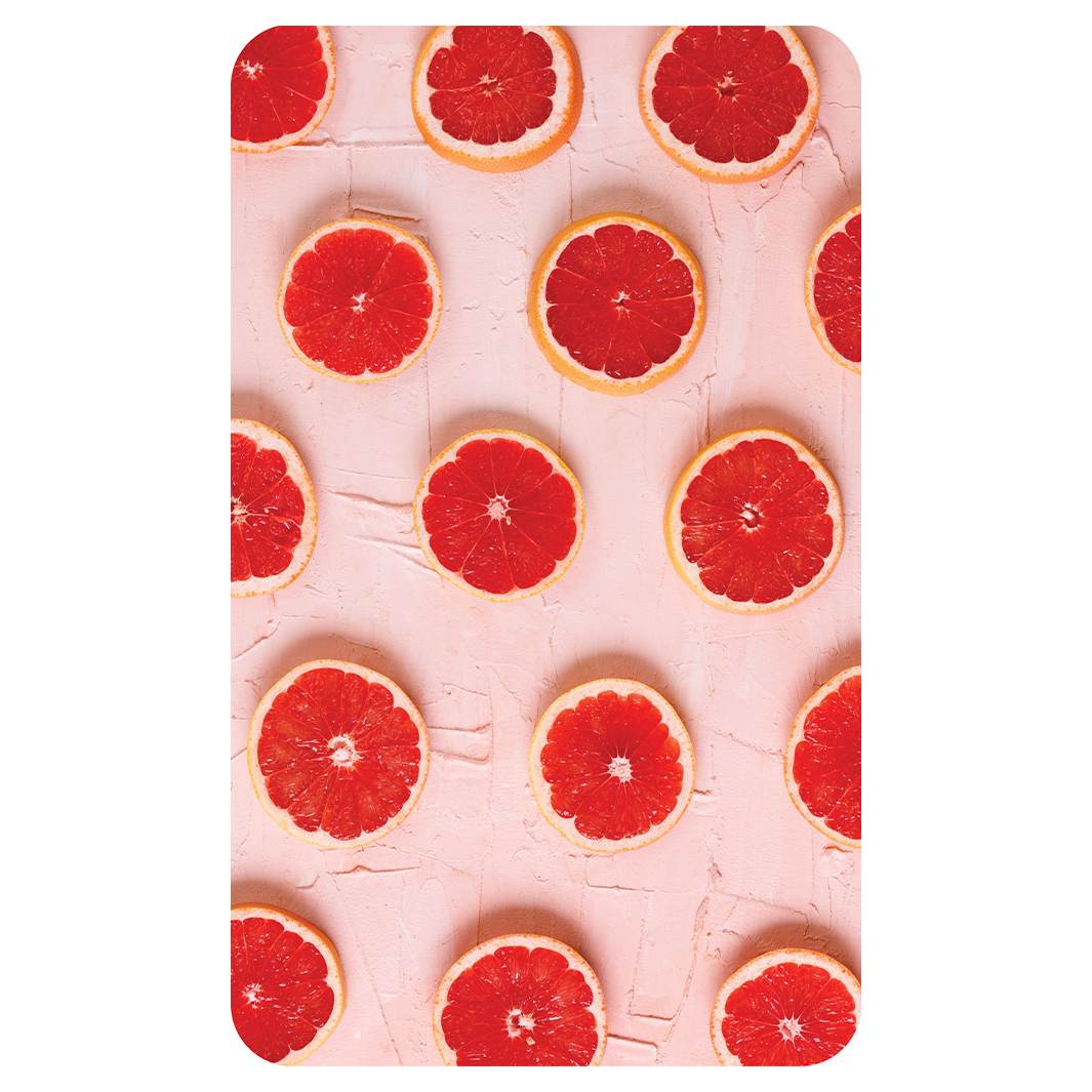 GRAPEFRUIT SLICES ON PINK KITCHEN TOWEL