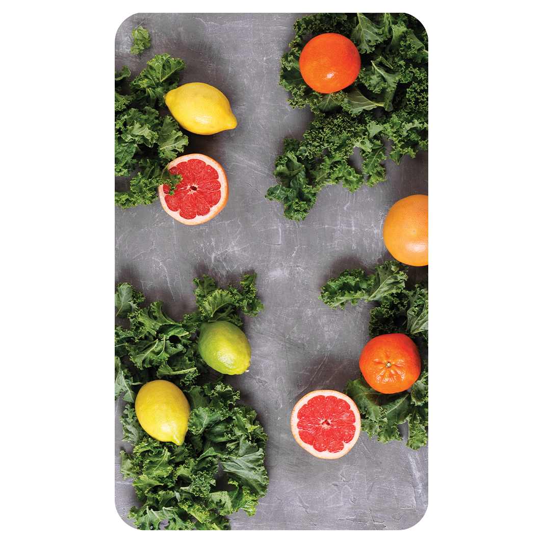 SCATTERED CITRUS AND KALE ON GREY KITCHEN TOWEL