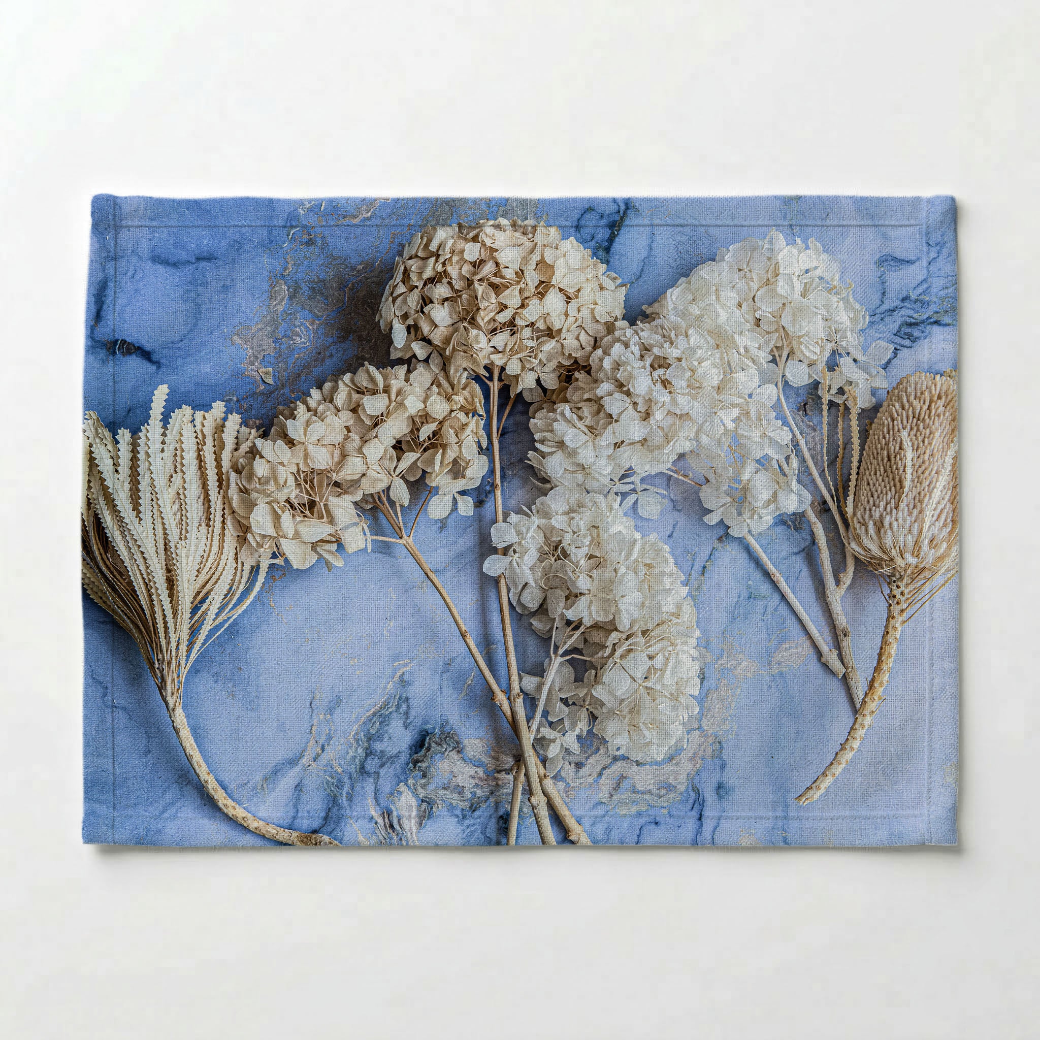 FLORAL CREAM BLEACHED HYDRANGEAS ON BLUE PLACEMAT