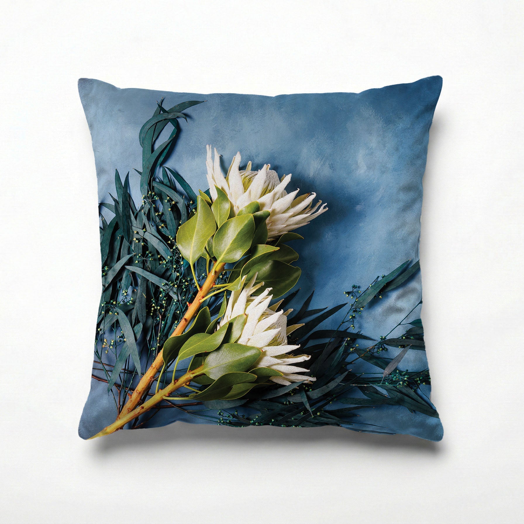 WHITE PROTEAS AND EUCALYPTUS ON BLUE SCATTER CUSHION