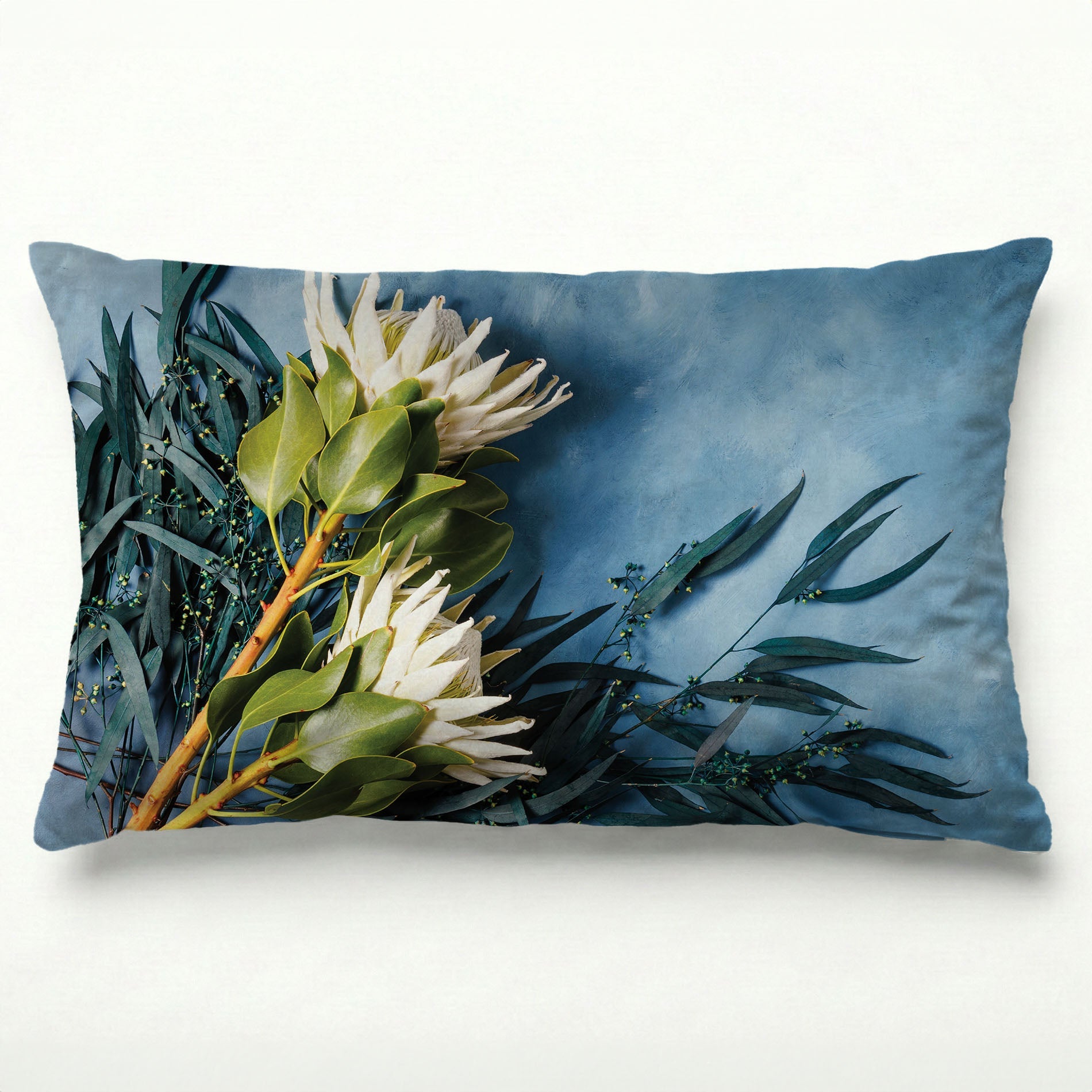 WHITE PROTEAS AND EUCALYPTUS ON BLUE SCATTER CUSHION