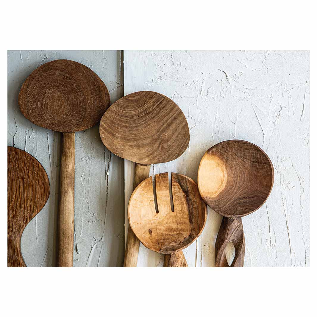 NATURAL BROWN WOODEN SPOONS ON GREY AND WHITE TABLECLOTH