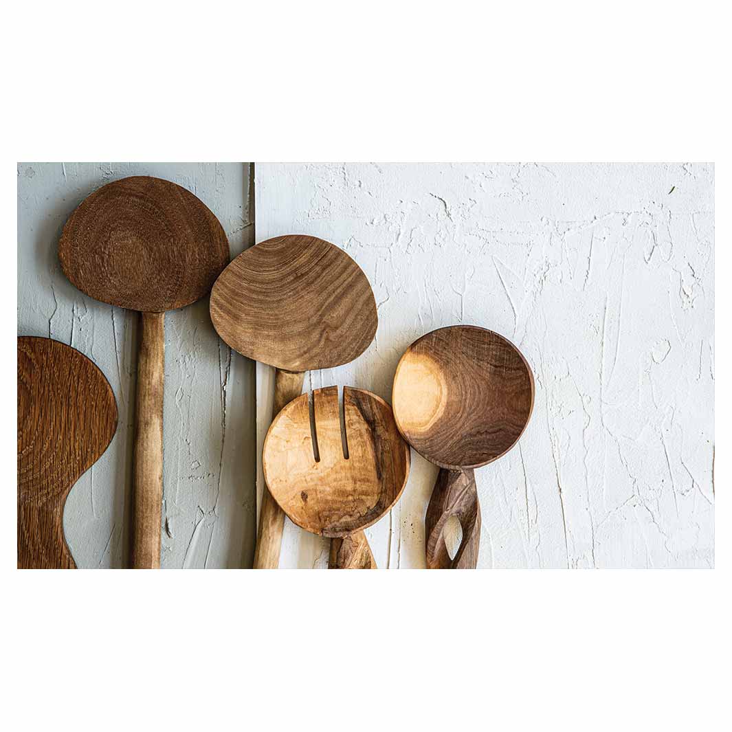 NATURAL BROWN WOODEN SPOONS ON GREY AND WHITE TABLECLOTH