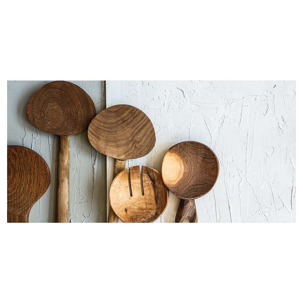 NATURAL BROWN WOODEN SPOONS ON GREY AND WHITE TABLECLOTH